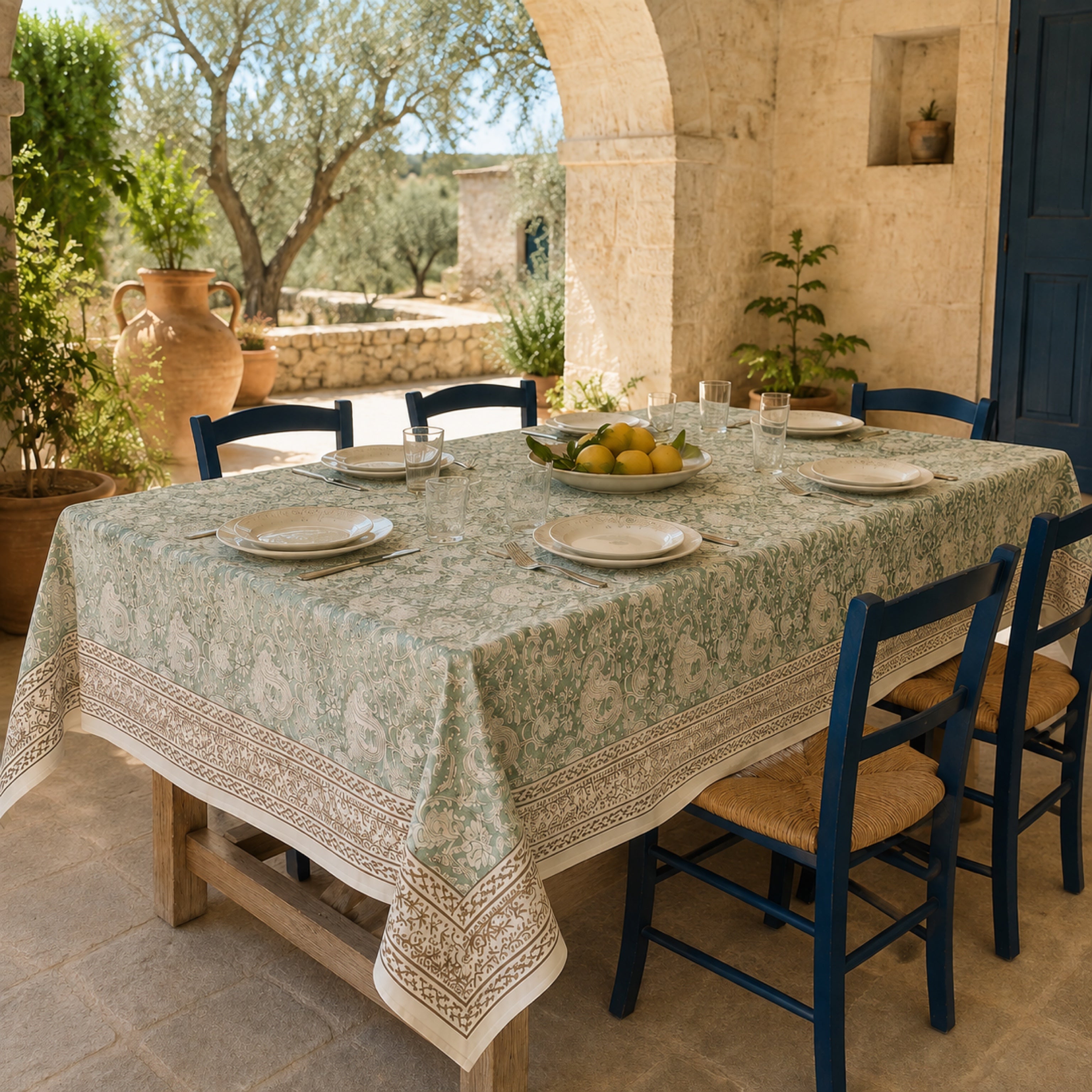 Sage Paisley Border Table Cover, styled on a dining table.