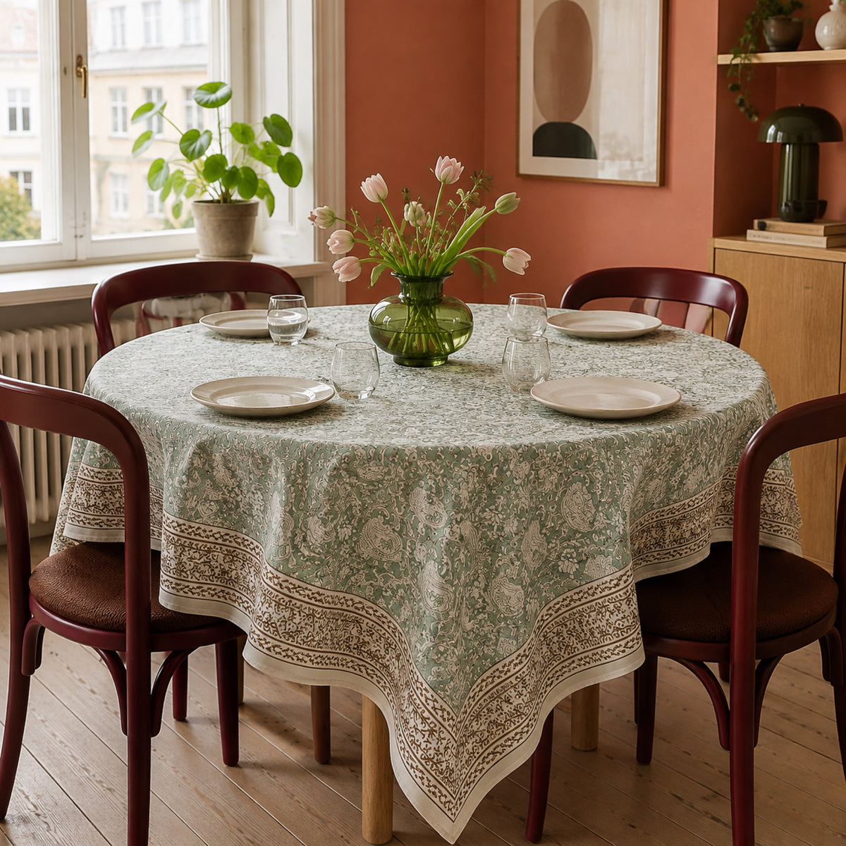 Sage Paisley Border Table Cover, styled on a dining table.