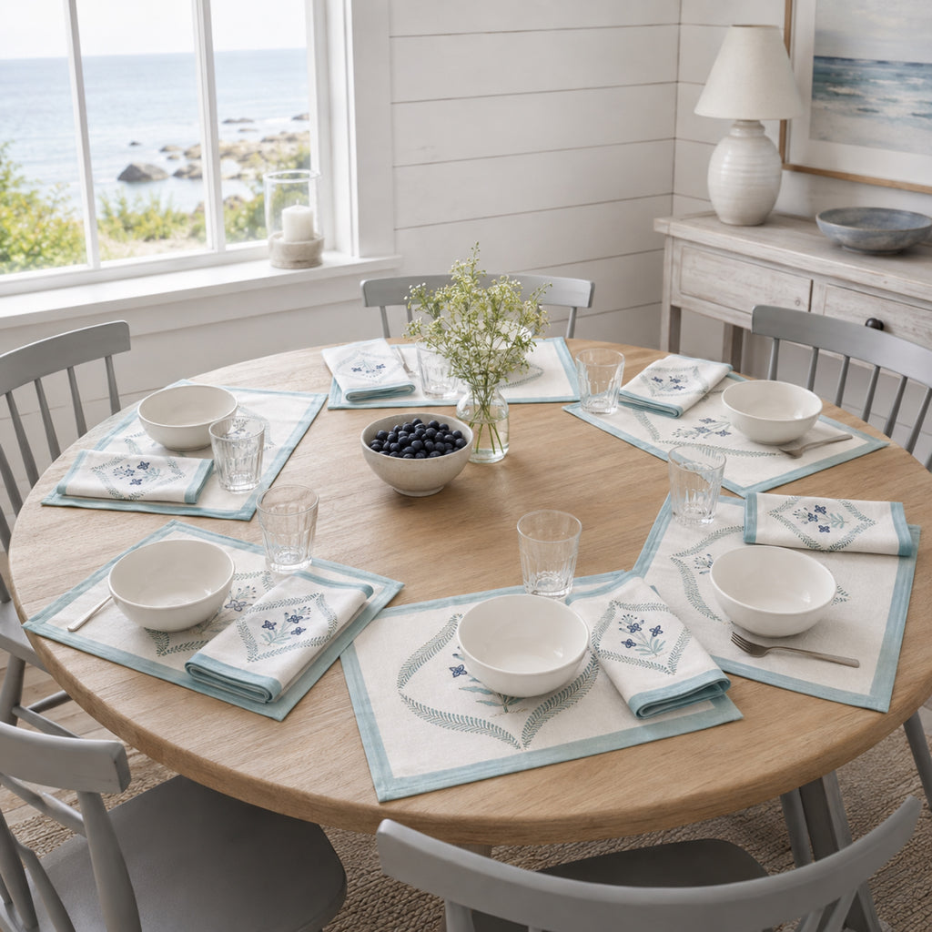 Powder Blue Botanical Wreath Mat & Napkin Set, styled on a dining table.