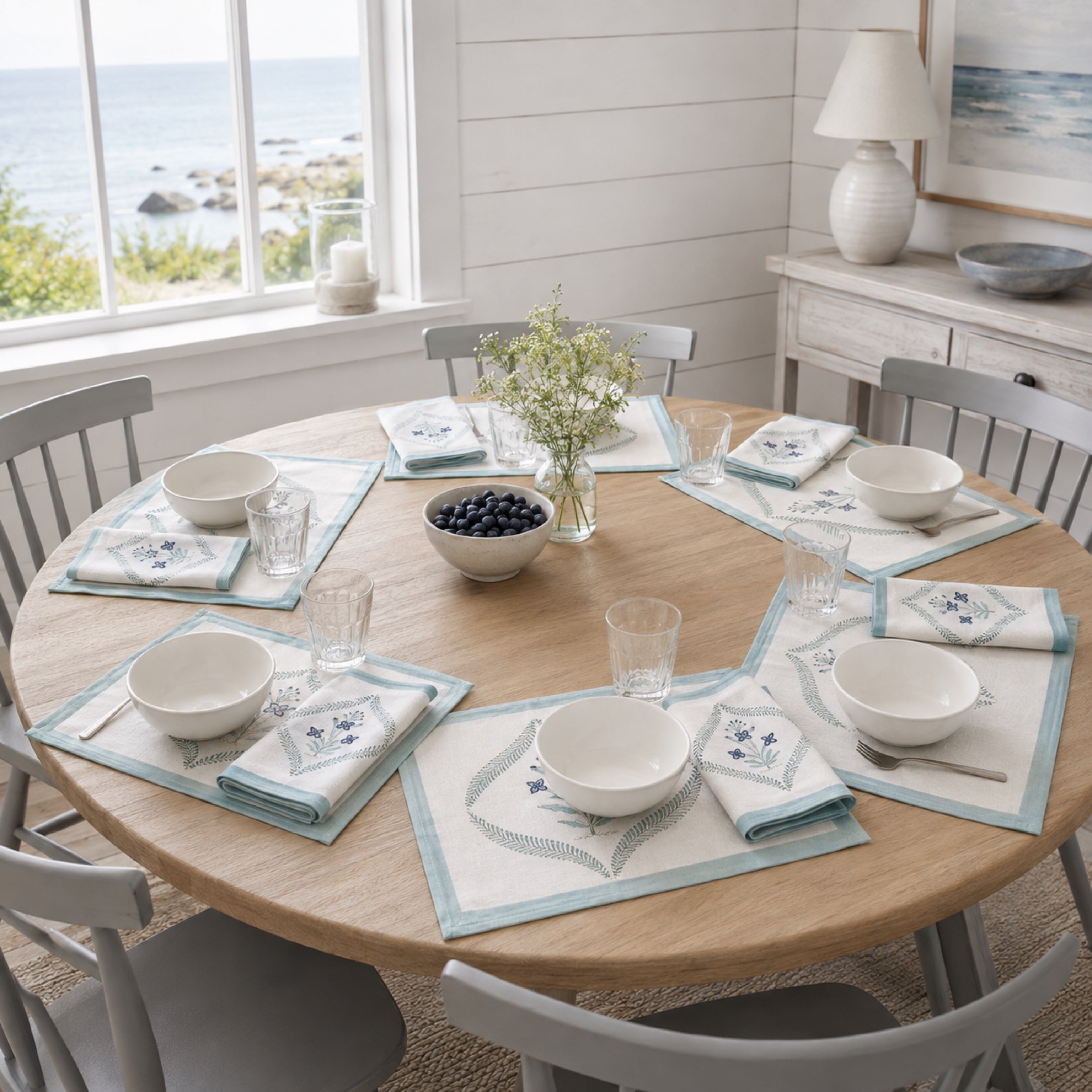 Powder Blue Botanical Wreath Mat & Napkin Set, styled on a dining table.