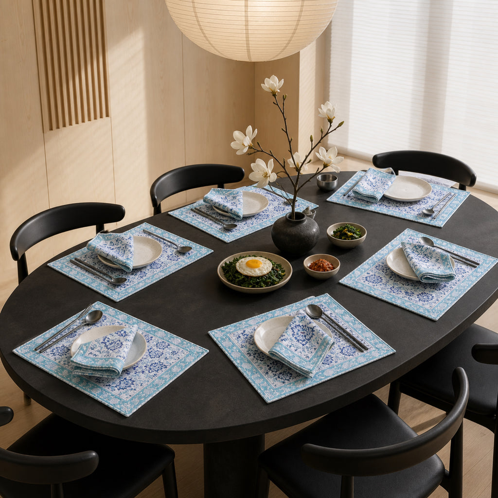 Sky Blue Floral Mat & Napkin Set, styled on a dining table.