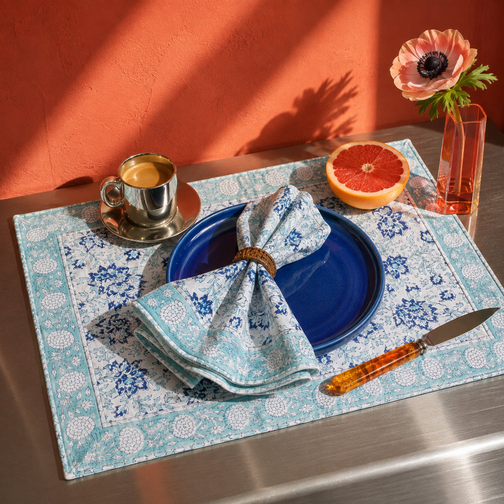 Sky Blue Floral Mat & Napkin Set, styled on a dining table.