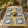 Sage Pom-Pom Floral Mat & Napkin Set, styled on a dining table.