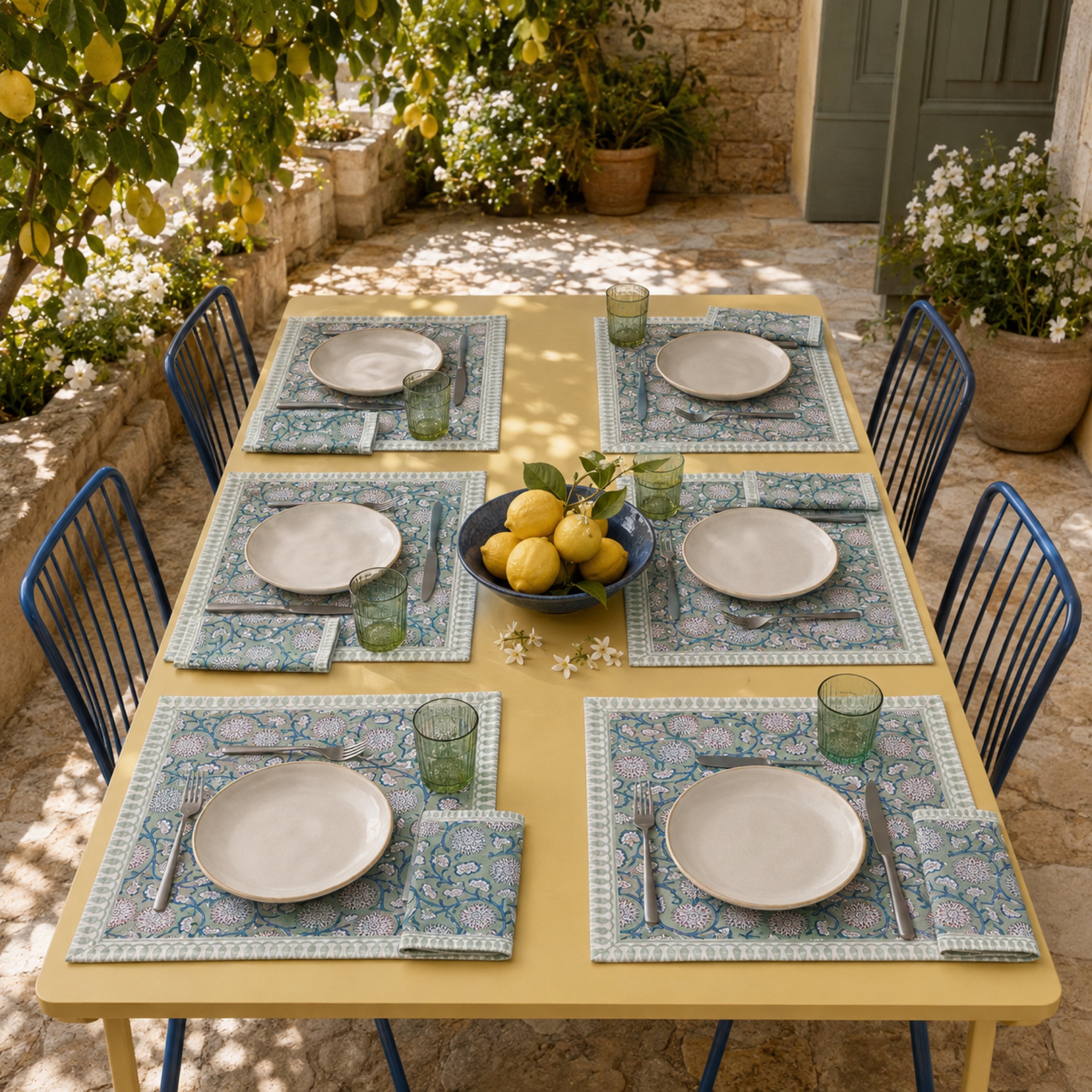 Sage Pom-Pom Floral Mat & Napkin Set, styled on a dining table.