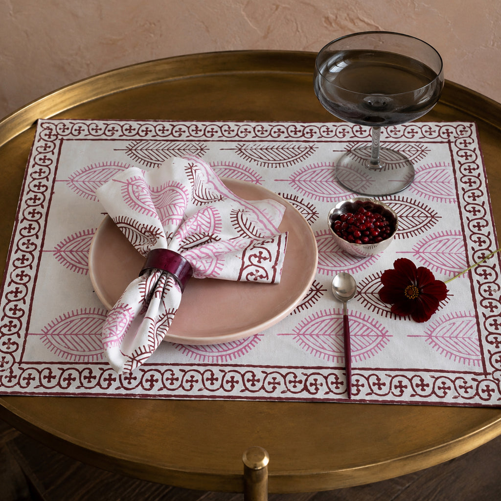 Dusty Pink Leaf Mat & Napkin Set, styled on a dining table.