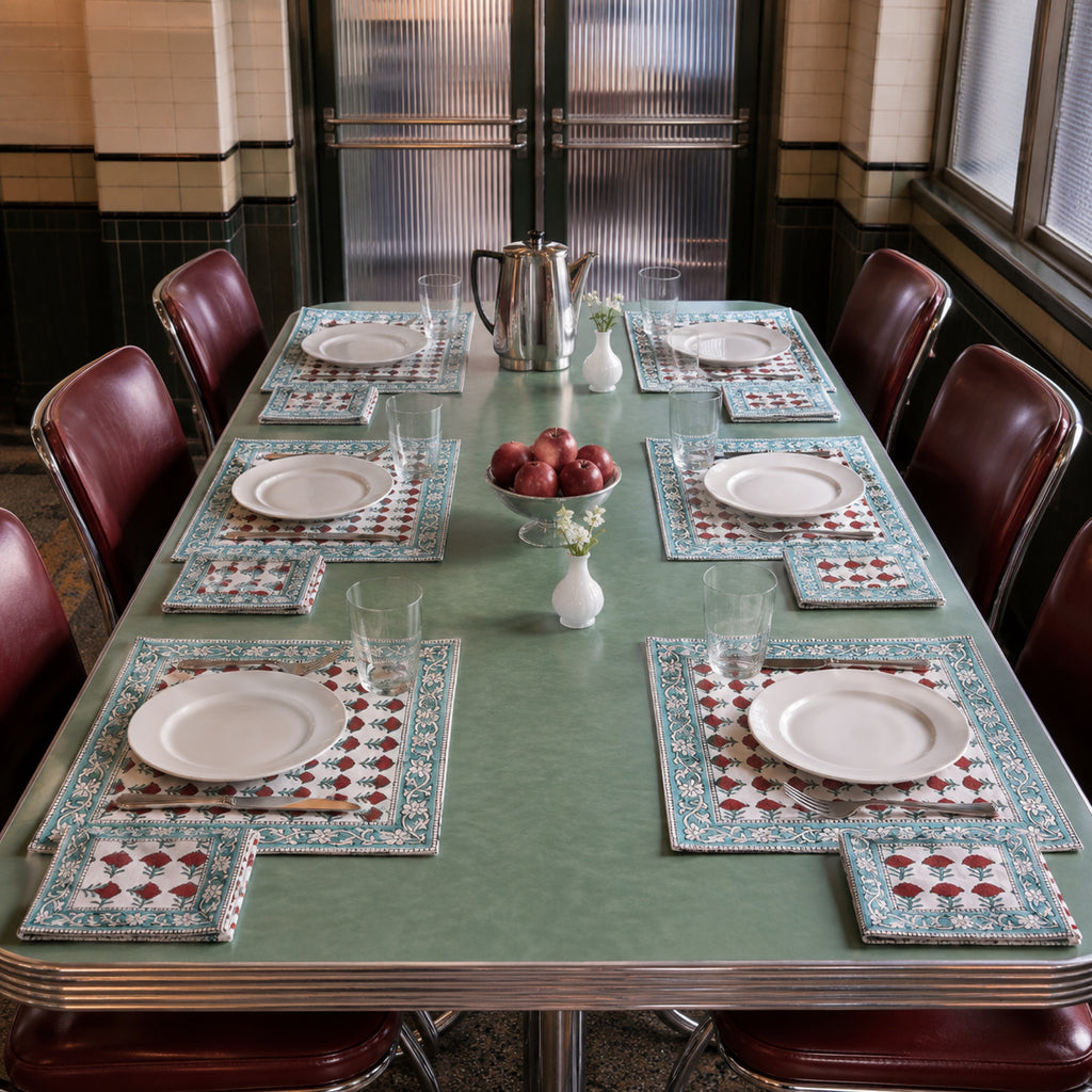 Red Marigold Aqua Border Mat & Napkin Set, styled on a dining table.