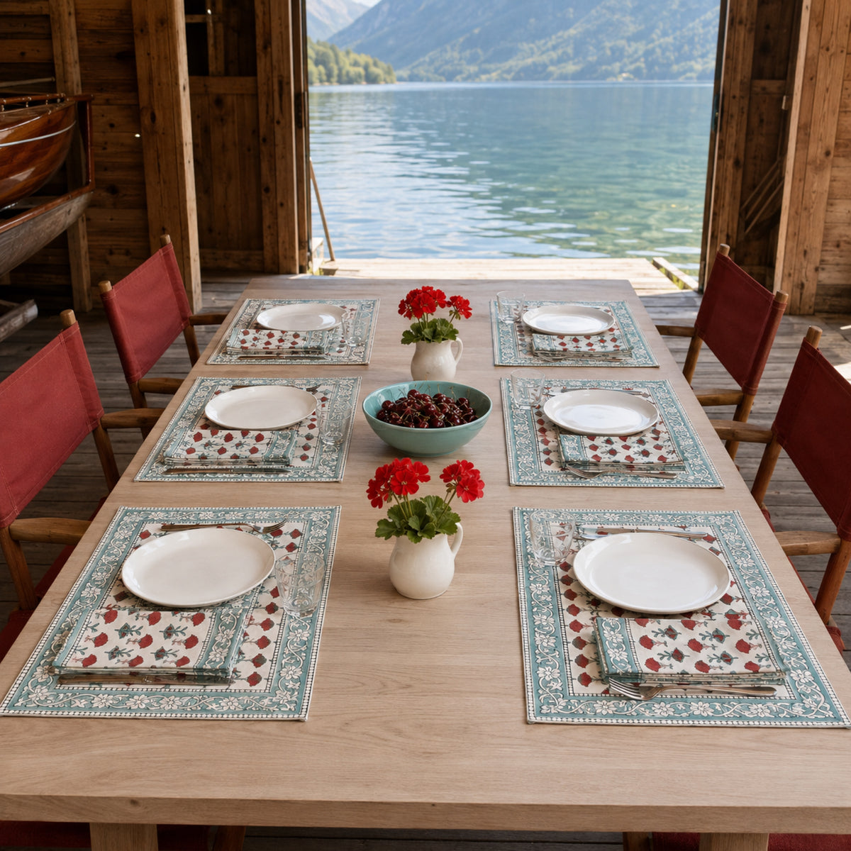 Red Marigold Aqua Border Mat & Napkin Set, styled on a dining table.
