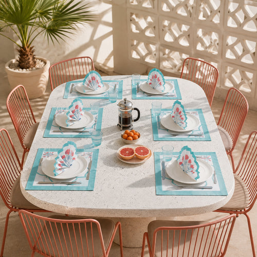 Aqua Scallop Coral Botanical Mat & Napkin Set, styled on a dining table.