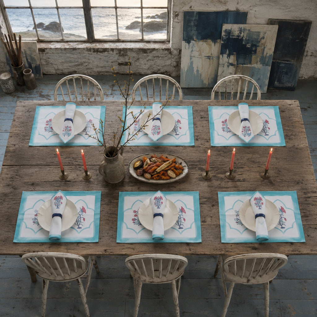 Aqua Scallop Coral Botanical Mat & Napkin Set, styled on a dining table.
