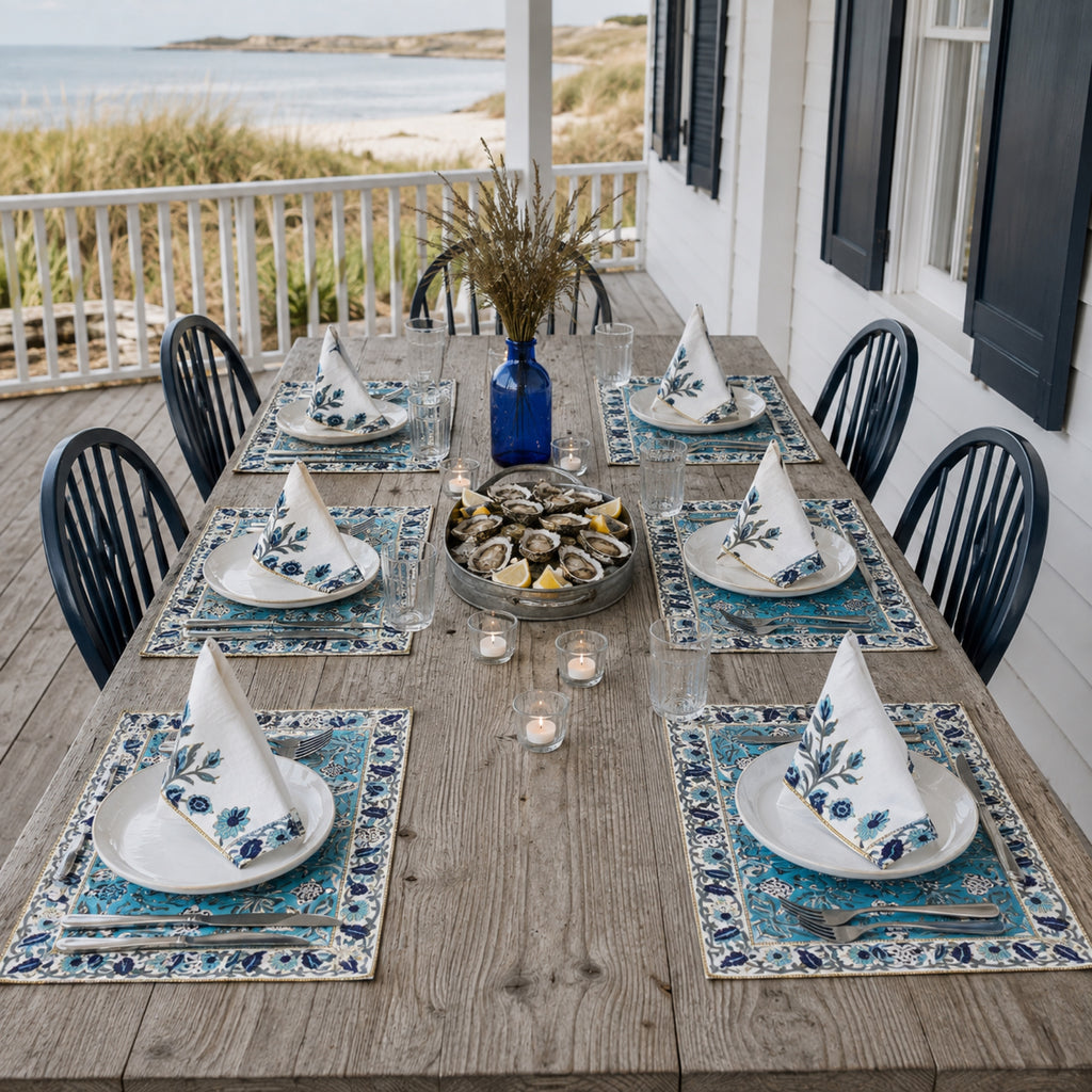 Turquoise Navy Floral Mat & Napkin Set, styled on a dining table.