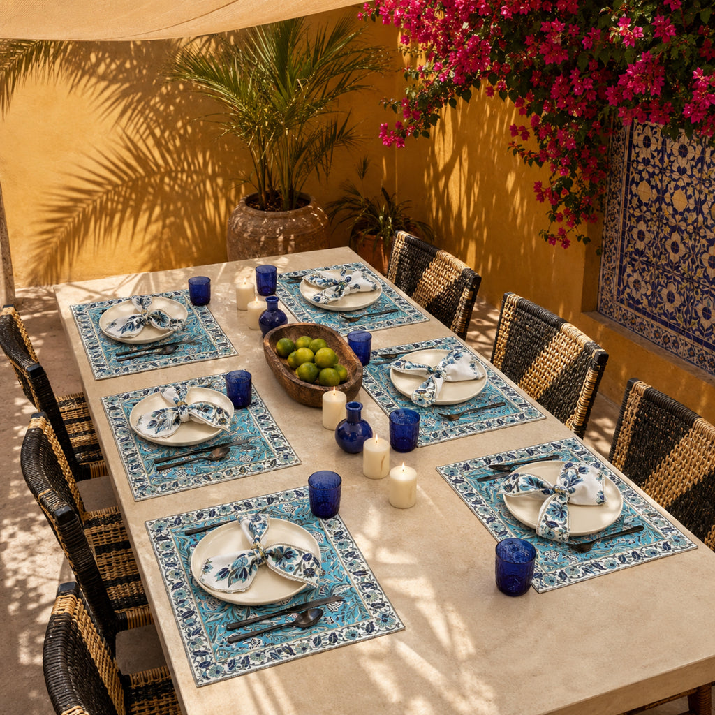 Turquoise Navy Floral Mat & Napkin Set, styled on a dining table.