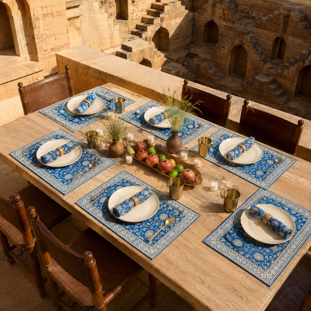 Cobalt Lotus Mat & Napkin Set, styled on a dining table.