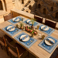 Cobalt Lotus Mat & Napkin Set, styled on a dining table.