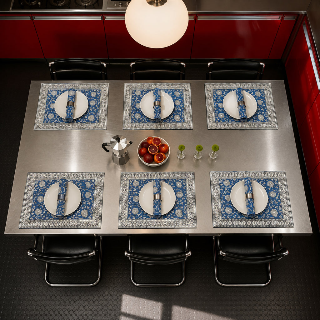 Cobalt Lotus Mat & Napkin Set, styled on a dining table.