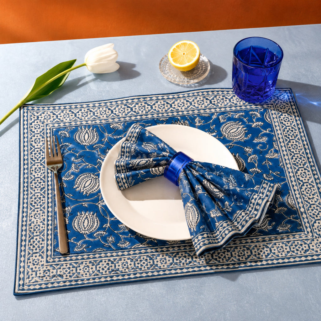 Cobalt Lotus Mat & Napkin Set, styled on a dining table.