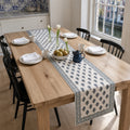 Indigo Bud Blue-Grey Border Table Runner, styled on a dining table.