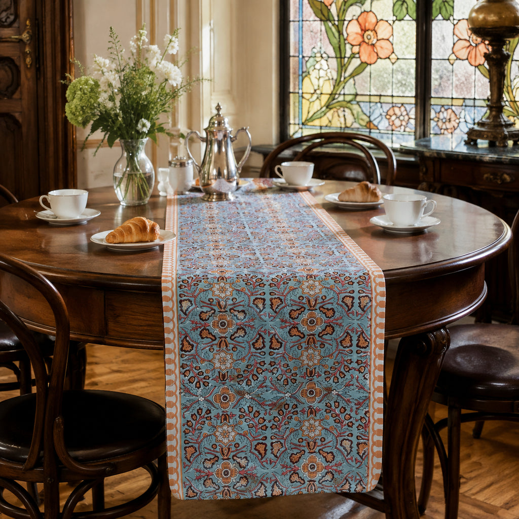 Turquoise Coral Arabesque Table Runner, styled on a dining table.