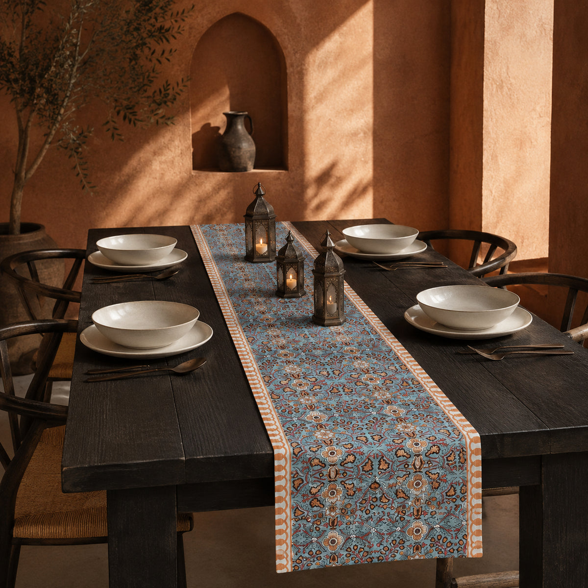 Turquoise Coral Arabesque Table Runner, styled on a dining table.