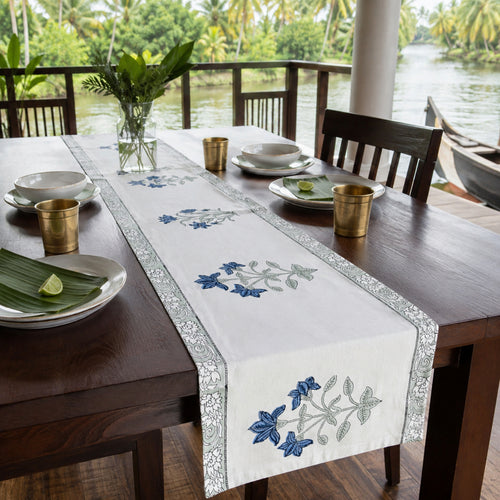 Blue Lily Sage Border Table Runner, styled on a dining table.