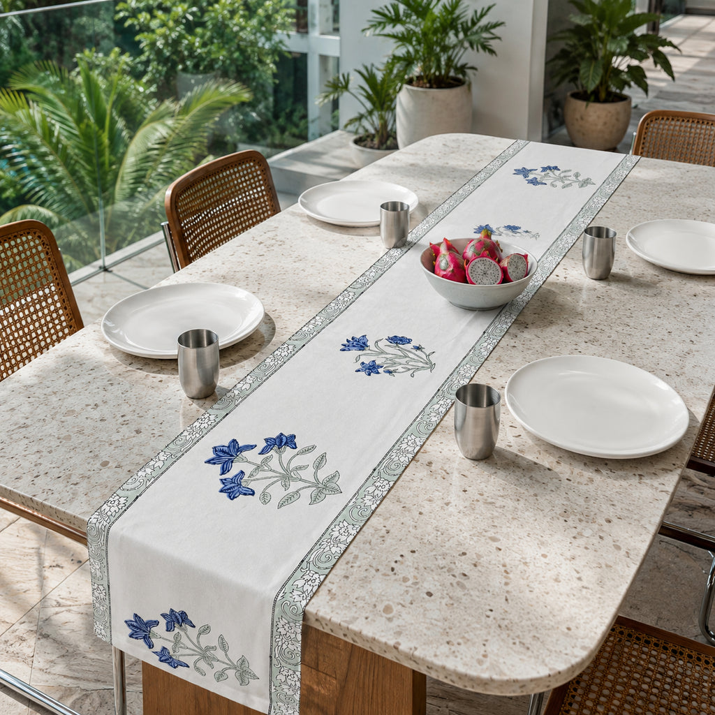 Blue Lily Sage Border Table Runner, styled on a dining table.