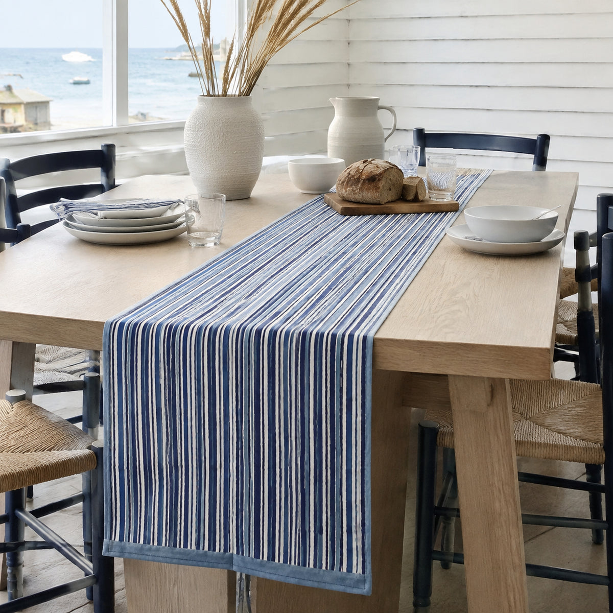 Indigo Stripe Table Runner, styled on a dining table.