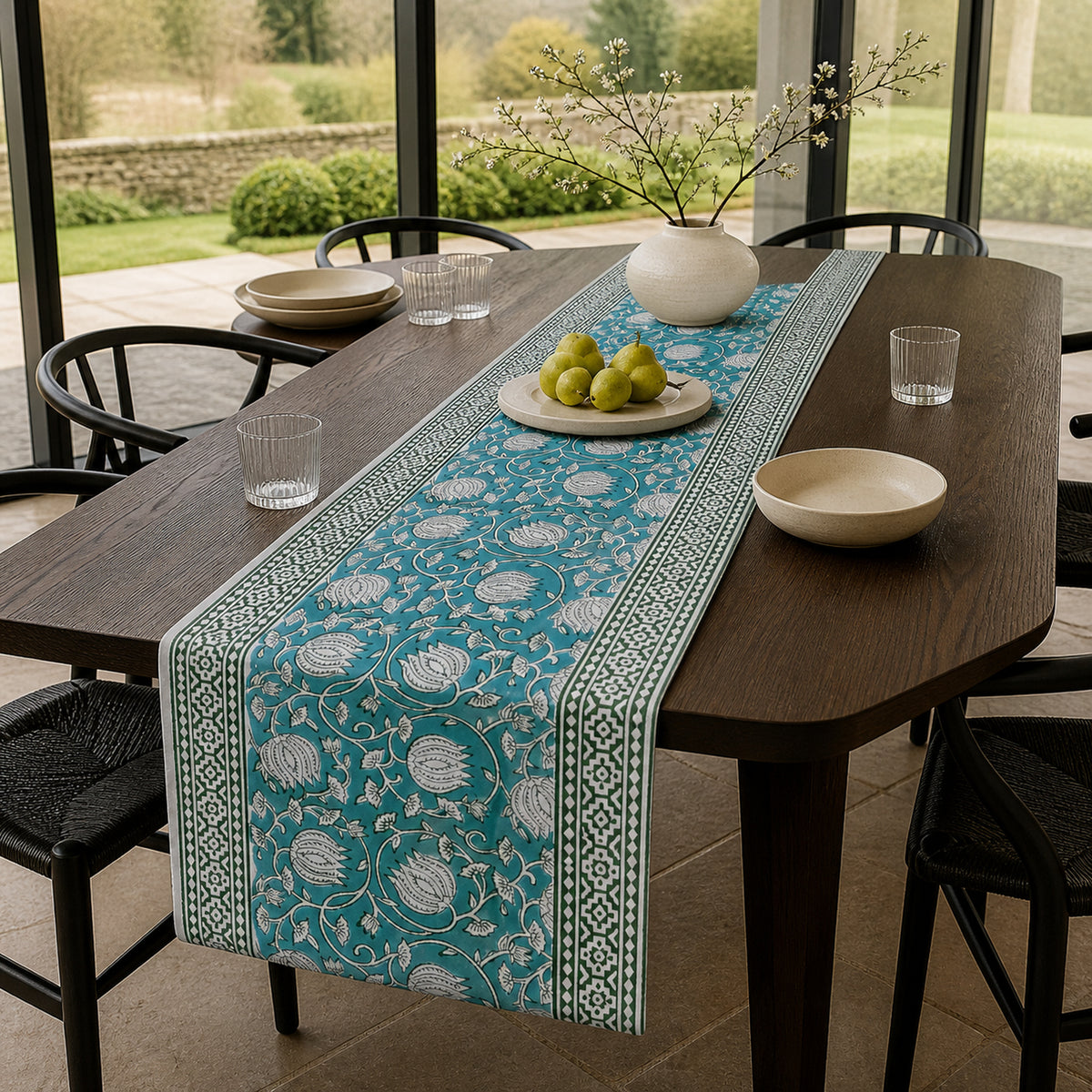 Teal Lotus Vine Table Runner, styled on a dining table.