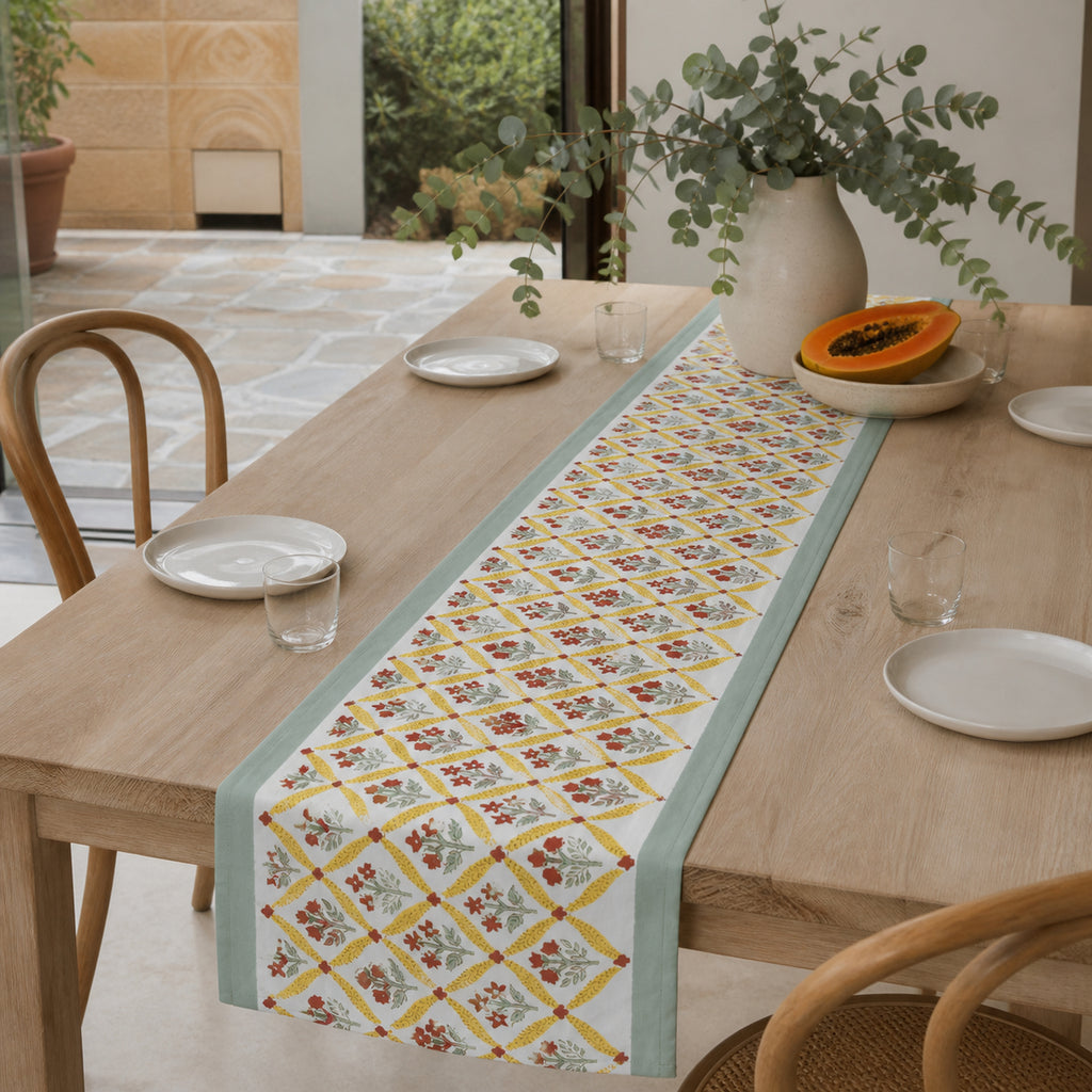 Mint Yellow Red Diamond Floral Table Runner, styled on a dining table.