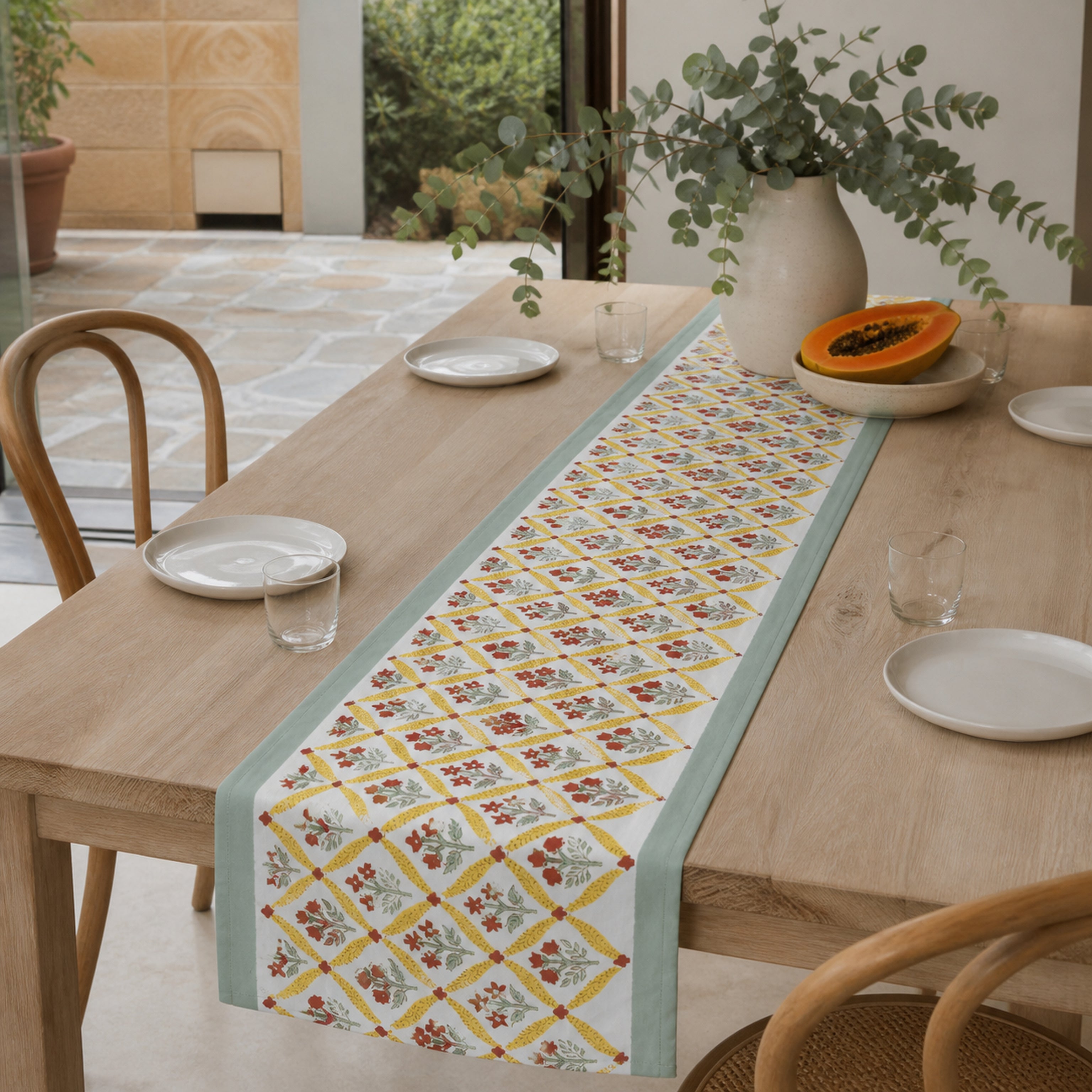 Mint Yellow Red Diamond Floral Table Runner, styled on a dining table.
