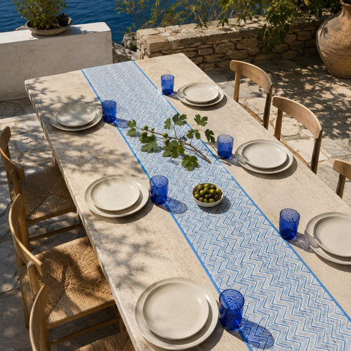 Blue Chevron Table Runner, styled on a dining table.