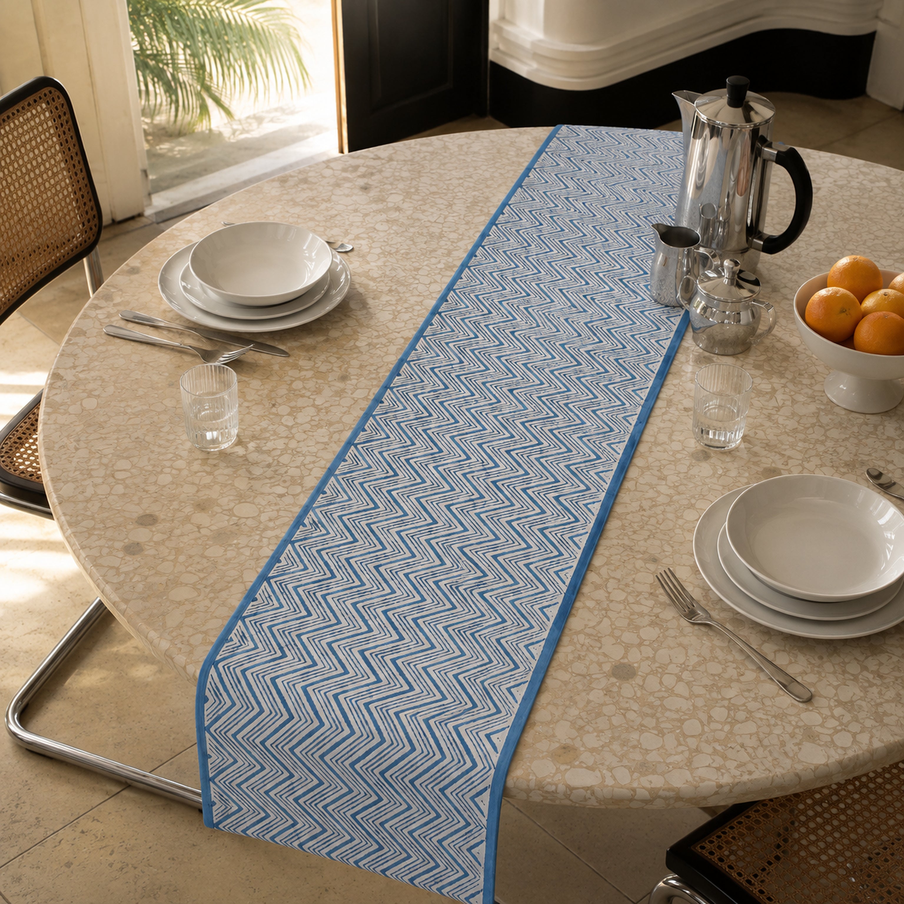 Blue Chevron Table Runner, styled on a dining table.