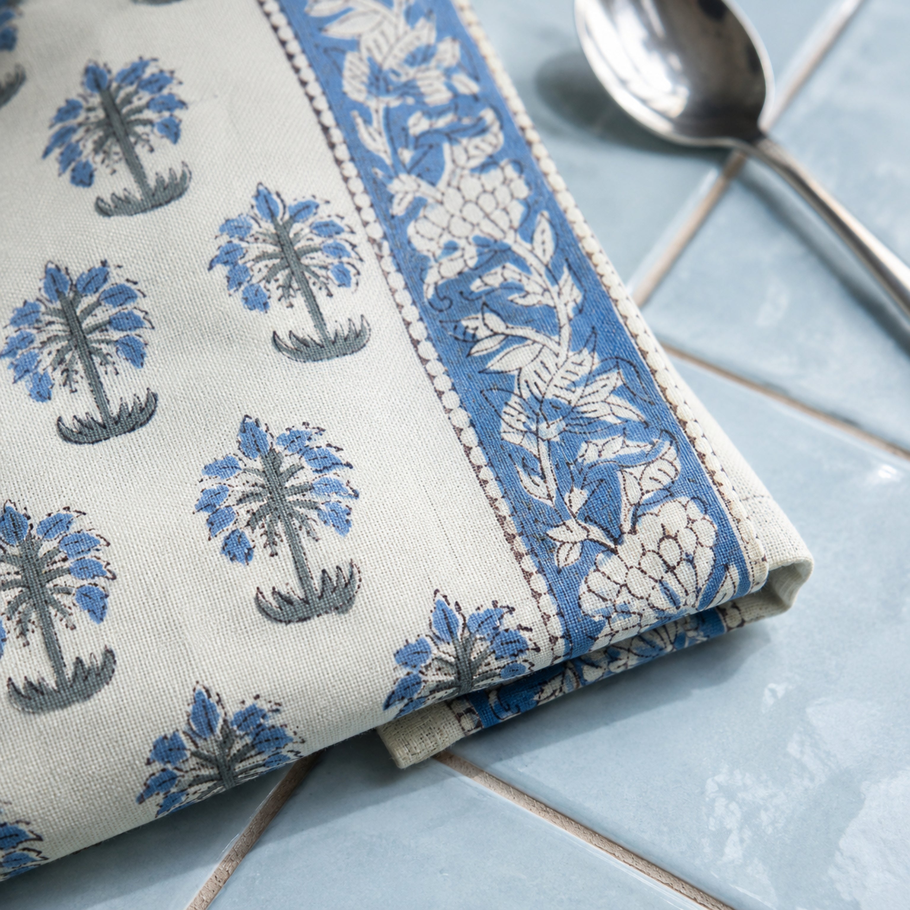 Sky Blue Palm Motif Table Runner, close-up of the print and edge details.